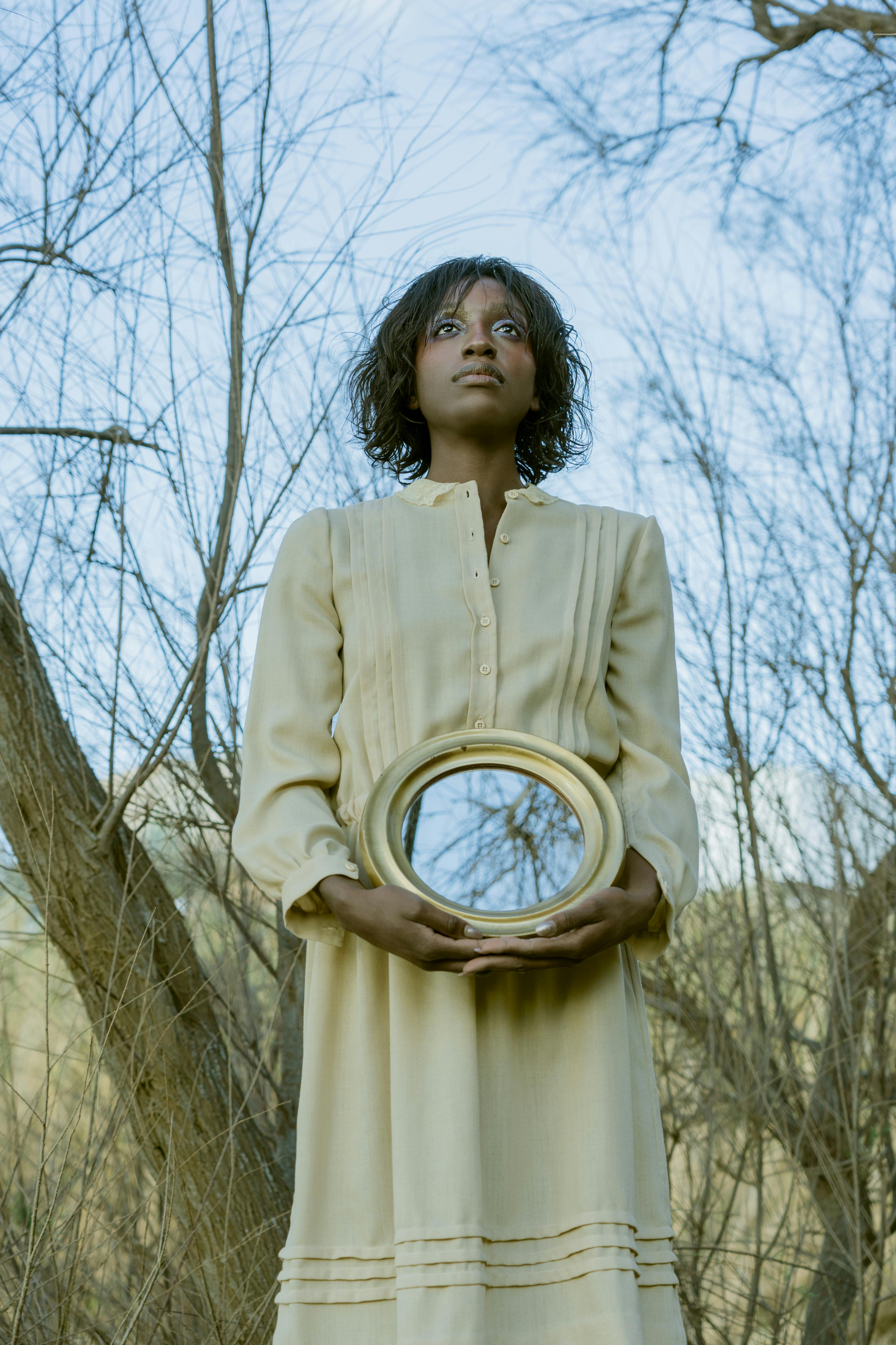 Woman holding a a mirror reflecting outward