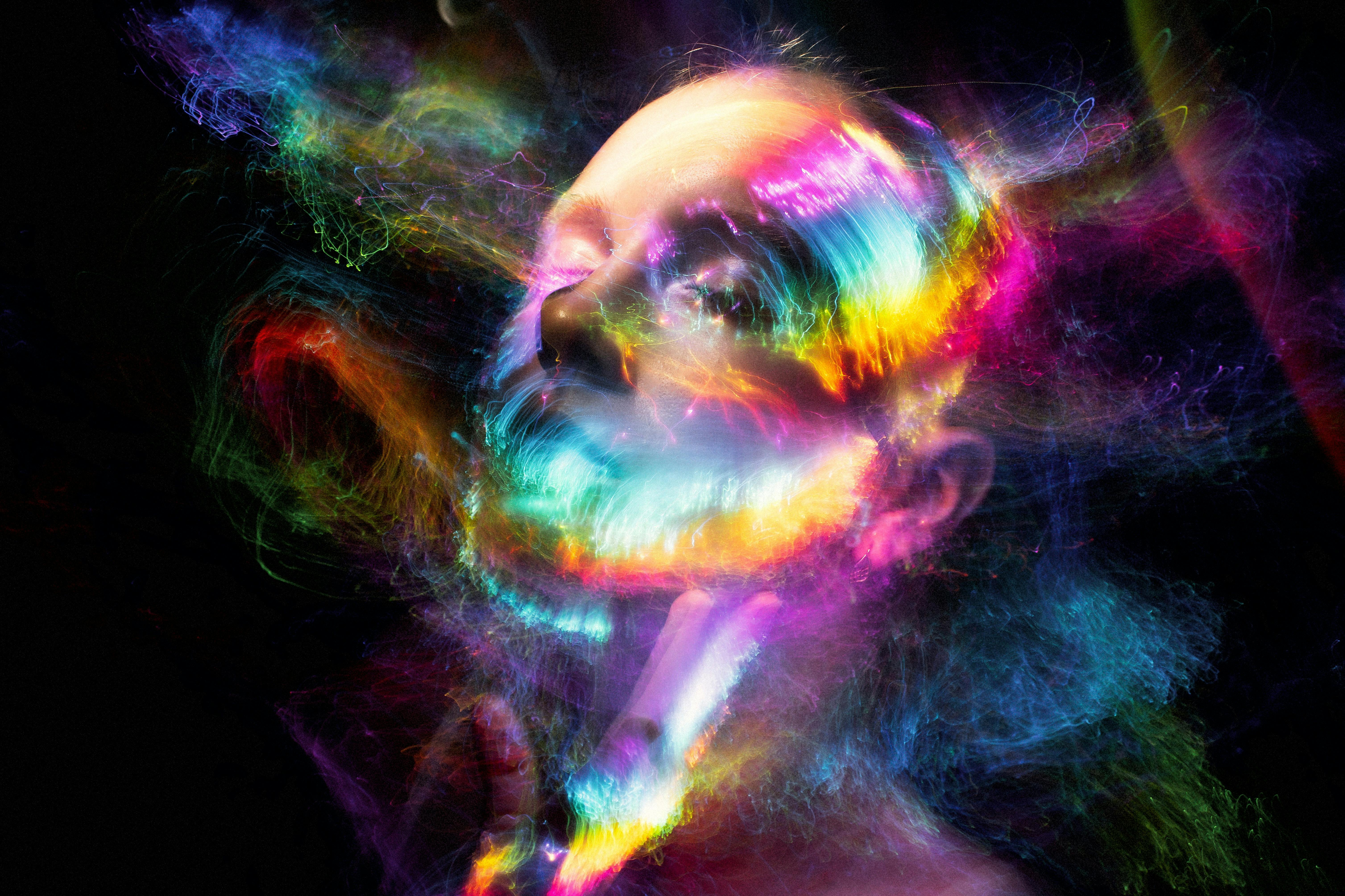 Woman's face surrounded by brilliant colors
